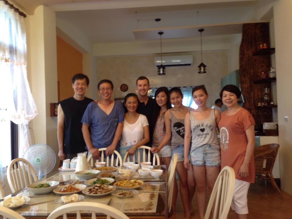 a group of people standing in front of a table at Hasayaki Homestay in Dayi