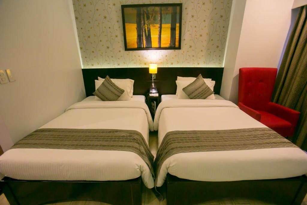 Postel nebo postele na pokoji v ubytování Venus Parkview Hotel
