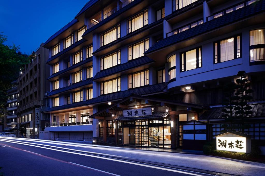 a building on a city street at night at Fujikawaguchiko Onsen Konanso in Fujikawaguchiko