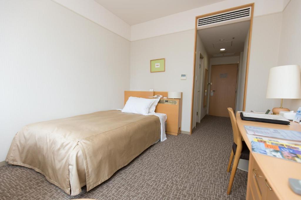 Postel nebo postele na pokoji v ubytování Hotel Lake View Mito