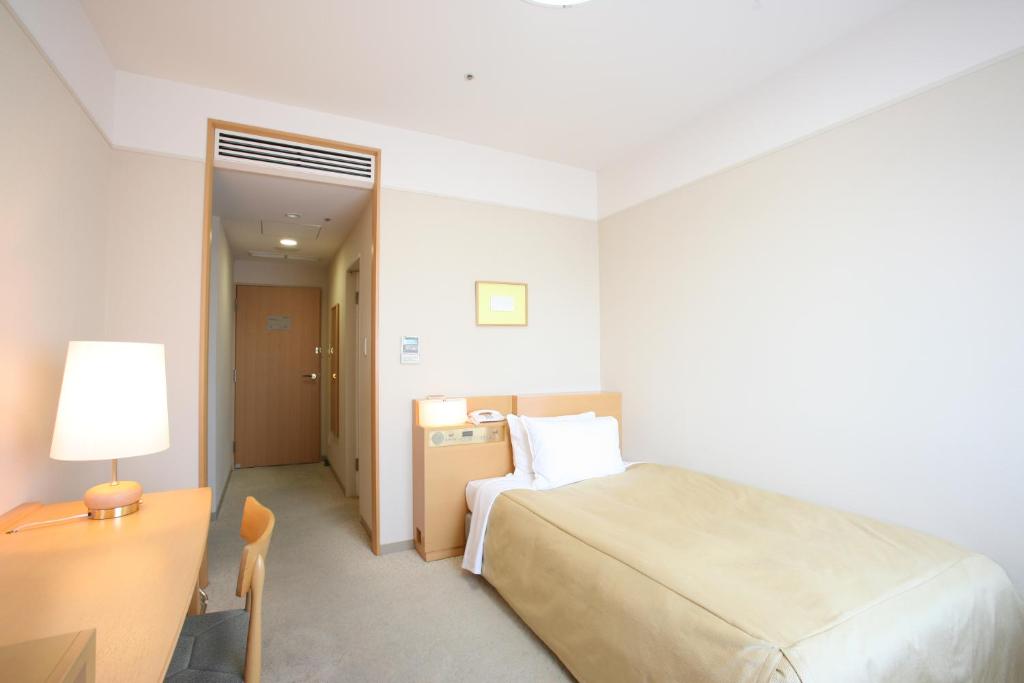 Postel nebo postele na pokoji v ubytování Hotel Lake View Mito