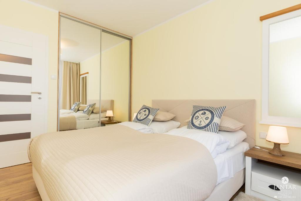 Posteľ alebo postele v izbe v ubytovaní Jantar Apartamenty Exclusive Polanki Park SPA