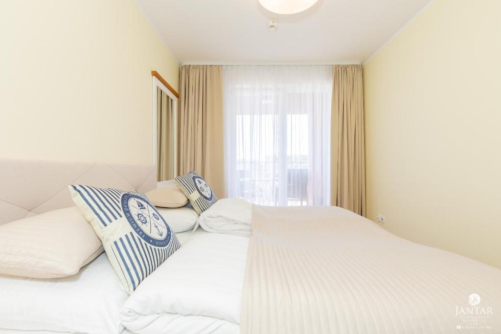 Posteľ alebo postele v izbe v ubytovaní Jantar Apartamenty Exclusive Polanki Park SPA