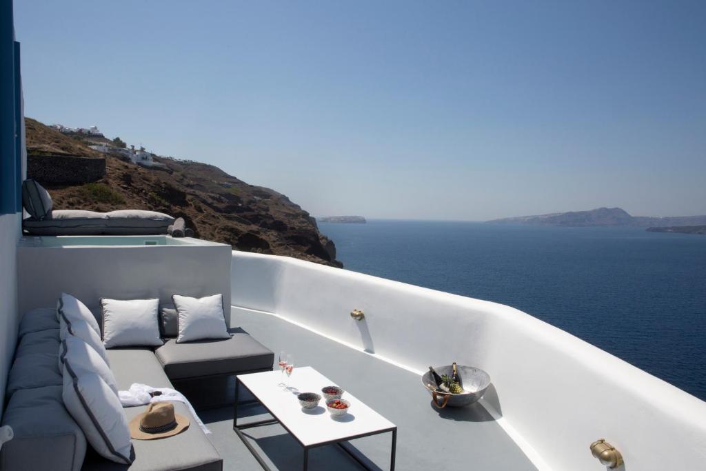 a balcony with a couch and a view of the ocean at Akrotiri Cove in Akrotiri