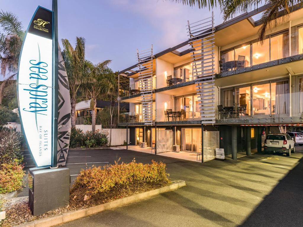 a building with a sign in front of it at Sea Spray Suites - Heritage Collection in Paihia