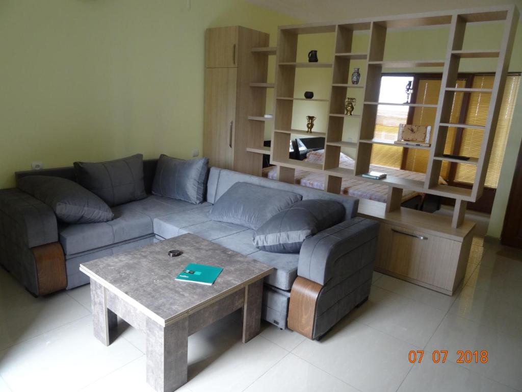 a living room with a couch and a table at LN'S APARTMENT in Borjomi