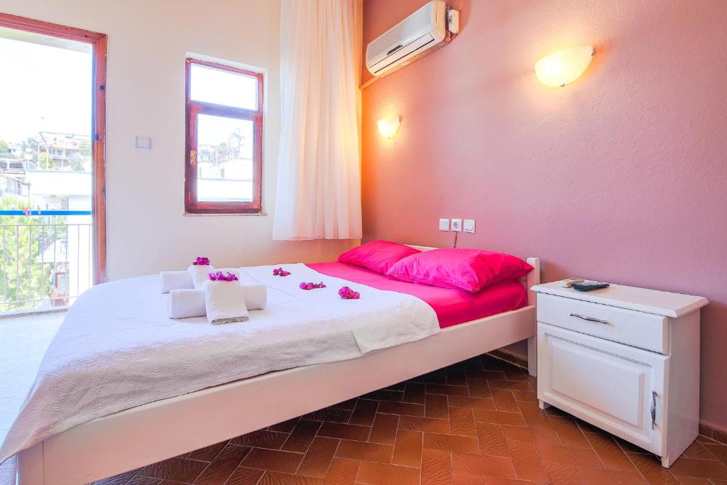 A bed or beds in a room at Saray Otel
