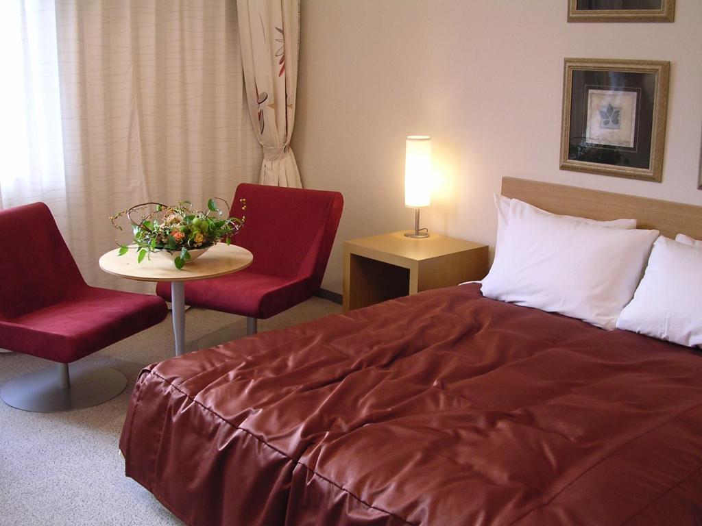 Postel nebo postele na pokoji v ubytování Hotel Lake View Mito