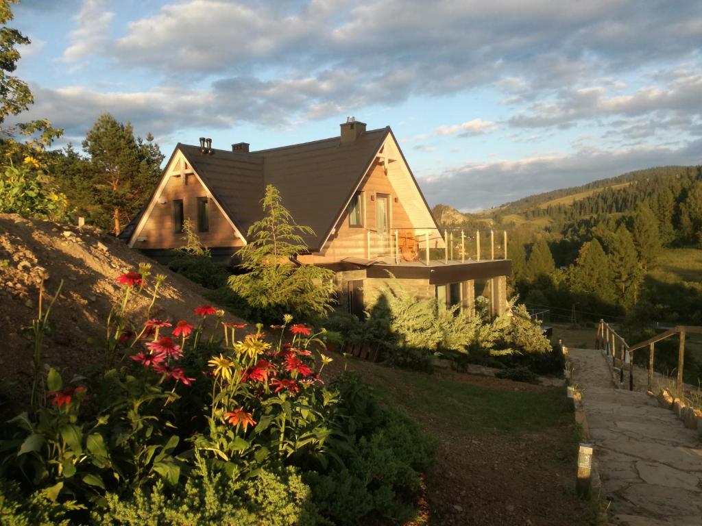 a house on a hill with flowers at Jaworki Green Dream in Szczawnica