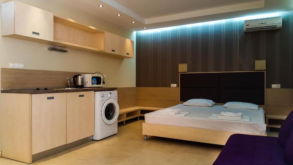 a room with a bed and a washing machine at Apart-Hotel Onegin & Thermal Zone in Sozopol