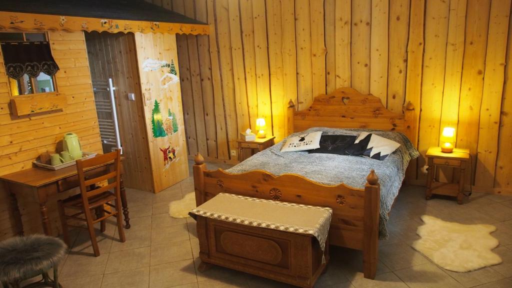 a bedroom with a bed in a log cabin at Chambres d'hôtes Olachat proche Annecy in Faverges