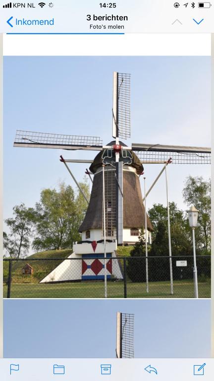 two pictures of a windmill in a field at De Heijense Molen Retro Camping in Heijen