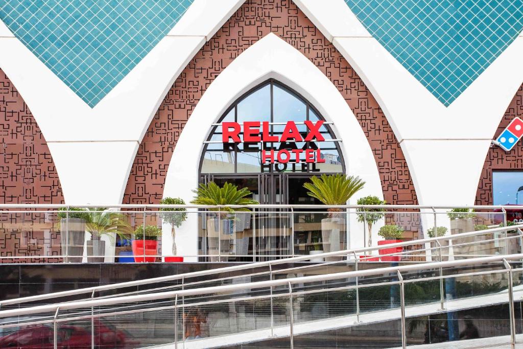 a large building with a sign on the side of it at Relax Hotel Casa Voyageurs in Casablanca