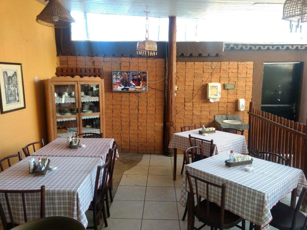 a restaurant with two tables in a room with at Hotel Pousada Marista in Goiânia