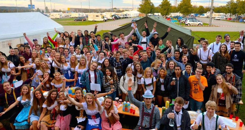 a large group of people posing for a picture at Festanation Oktoberfest Camp #1 in Munich