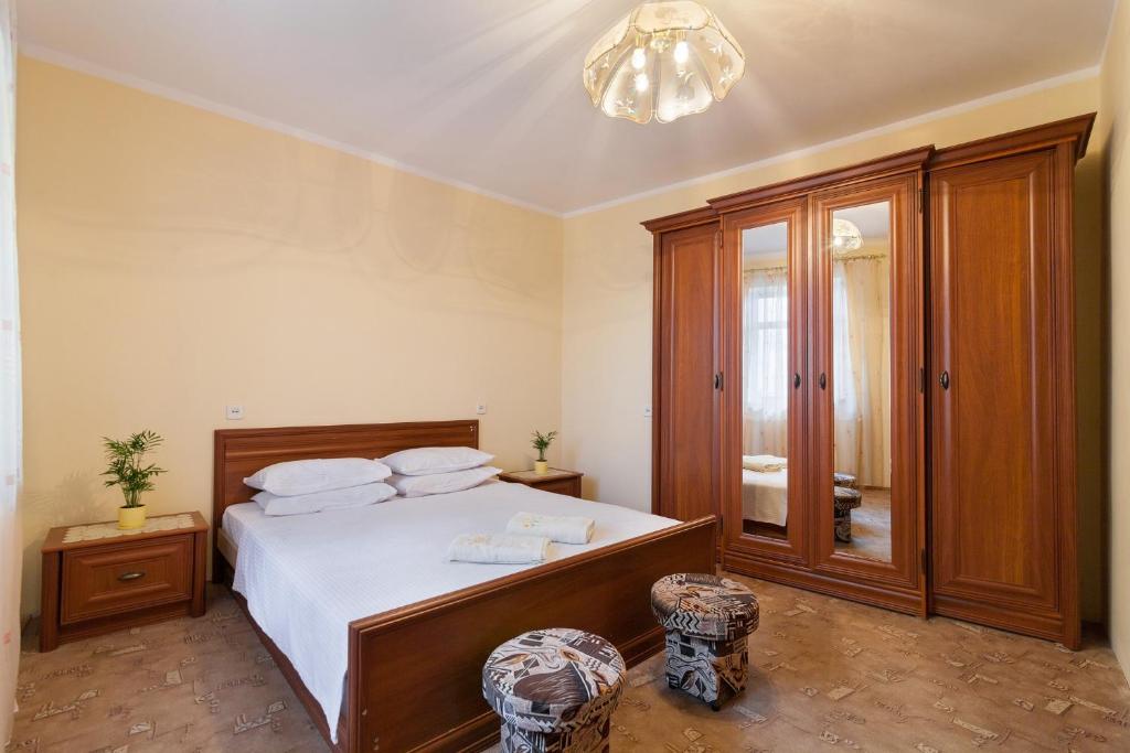 a bedroom with a bed and a chandelier at Paradise apartments in Lviv