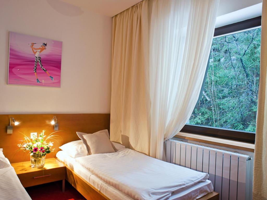 Postel nebo postele na pokoji v ubytování Hotel Stupka