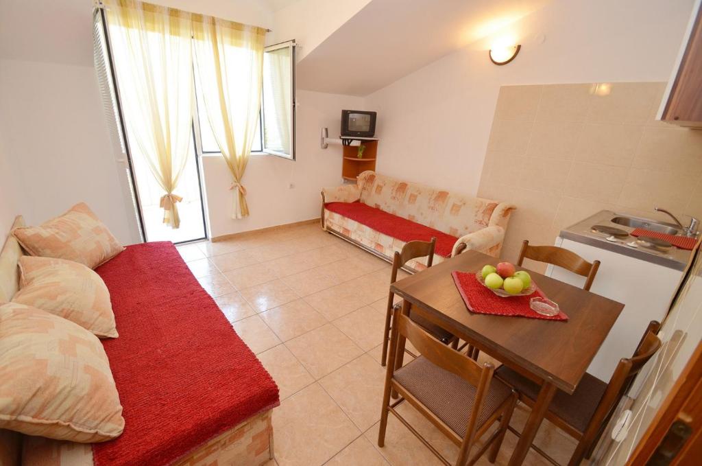 a living room with a couch and a table at Apartmani Prcanj in Kotor