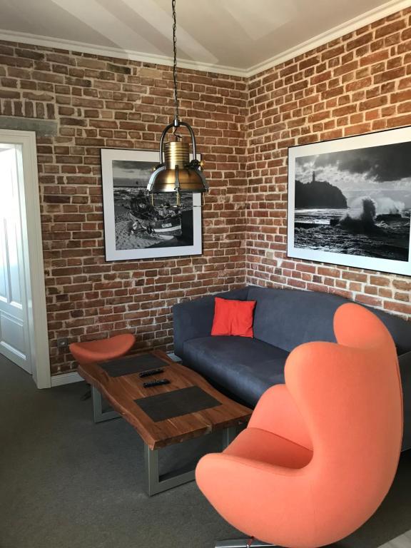 a living room with a couch and a table at Willa Oktawia in Niechorze