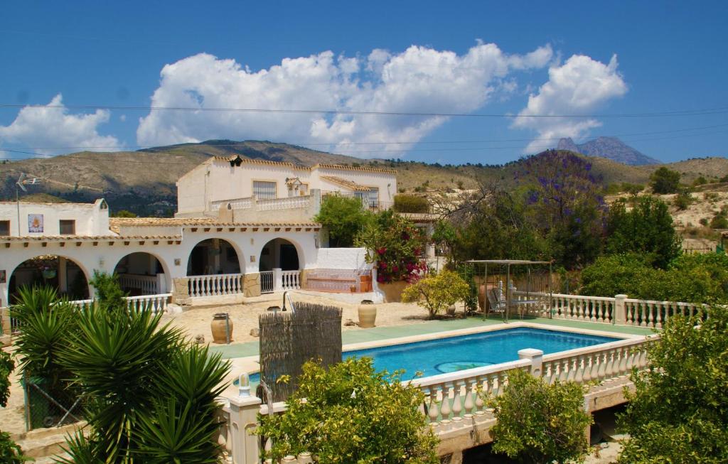 a villa with a swimming pool and a house at Casas Rurales Delfos in Villajoyosa
