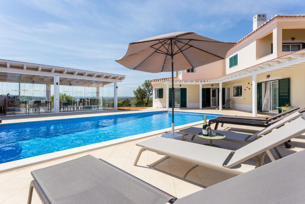 a villa with a swimming pool and a house at The Sun Hill in Lagos