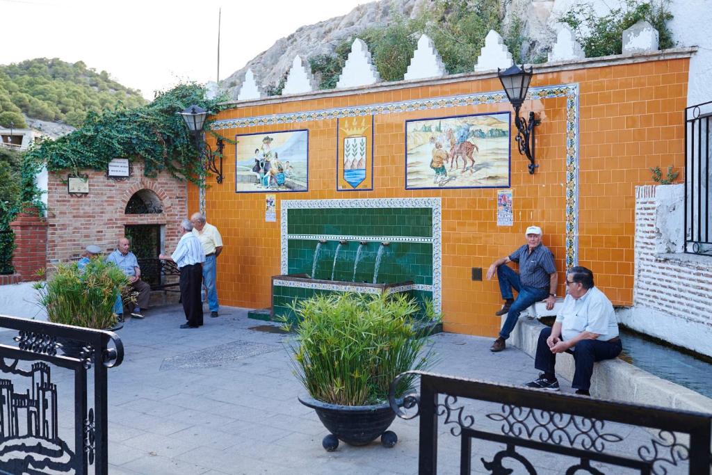 people standing outside of a building at Hotel Casa de los Arcos in Vélez Blanco