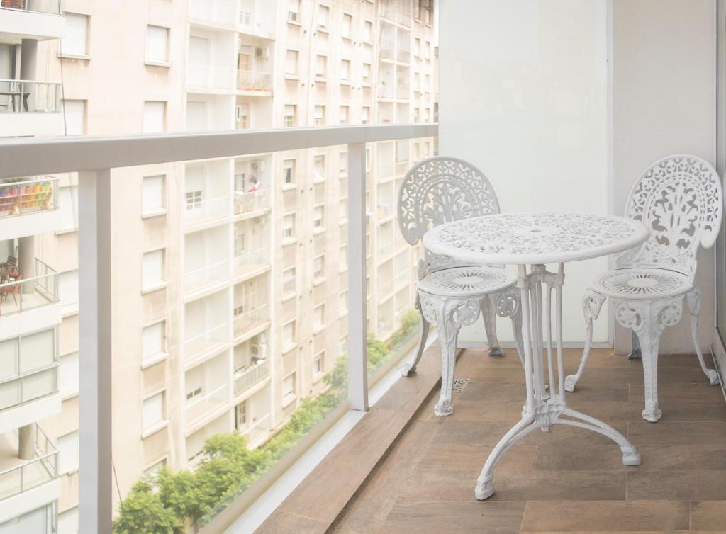 un balcón con 2 sillas y una mesa en el balcón en Flat in Las Cañitas. en Buenos Aires
