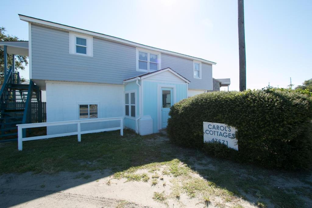 a house with a sign in front of it at Outer Banks Motel - Village Accommodations in Buxton