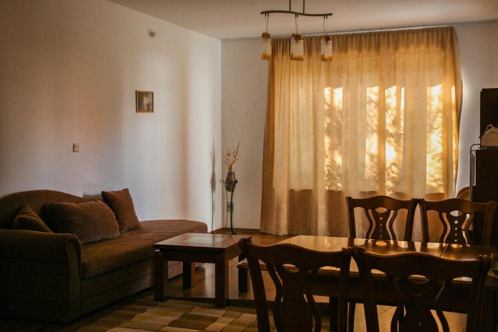 a living room with a couch and a table at Apart-Hotel Onegin & Thermal Zone in Sozopol