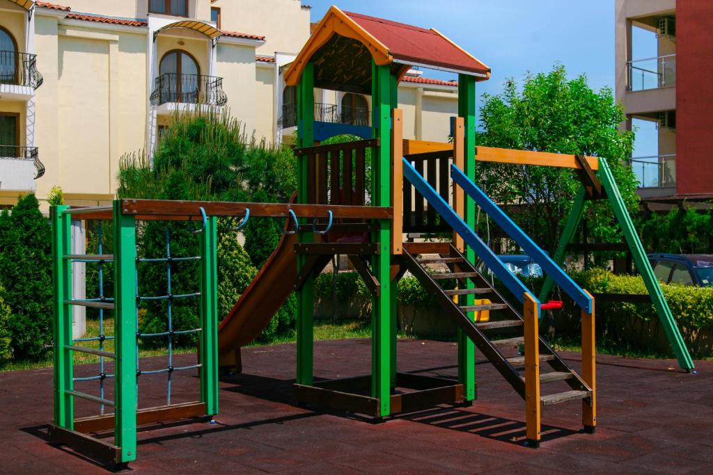 a playground with a slide in front of a building at Apart-Hotel Onegin & Thermal Zone in Sozopol