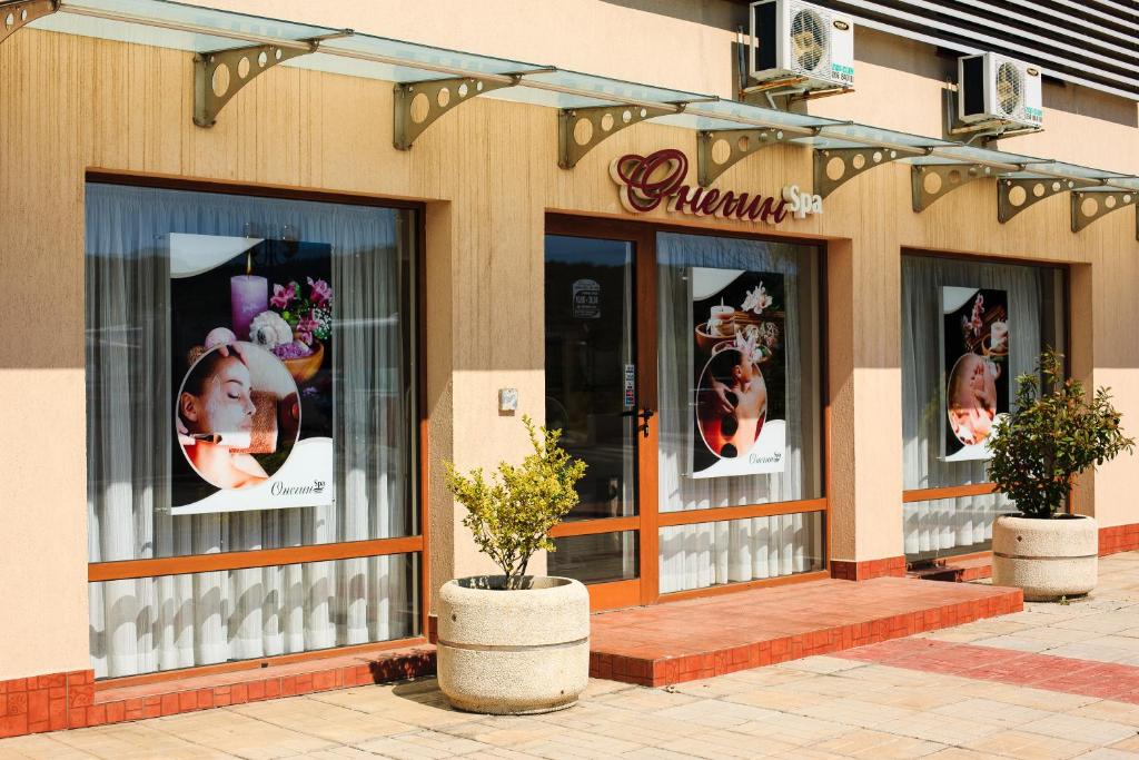 a store front with windows with pictures of women at Apart-Hotel Onegin & Thermal Zone in Sozopol