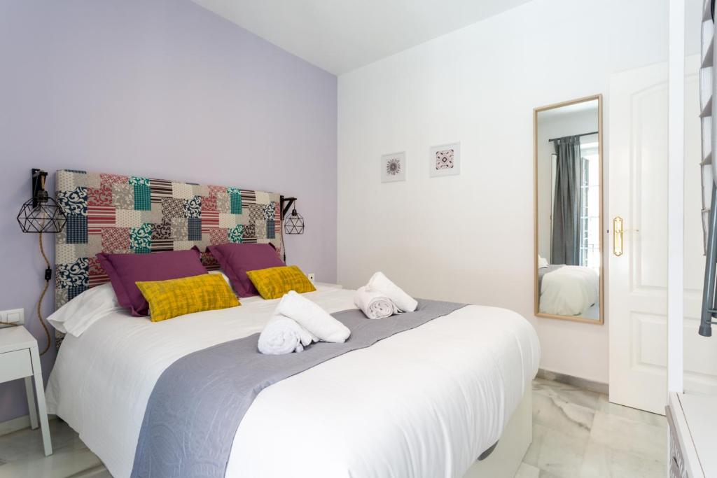 Posteľ alebo postele v izbe v ubytovaní Uniko Home Sevilla