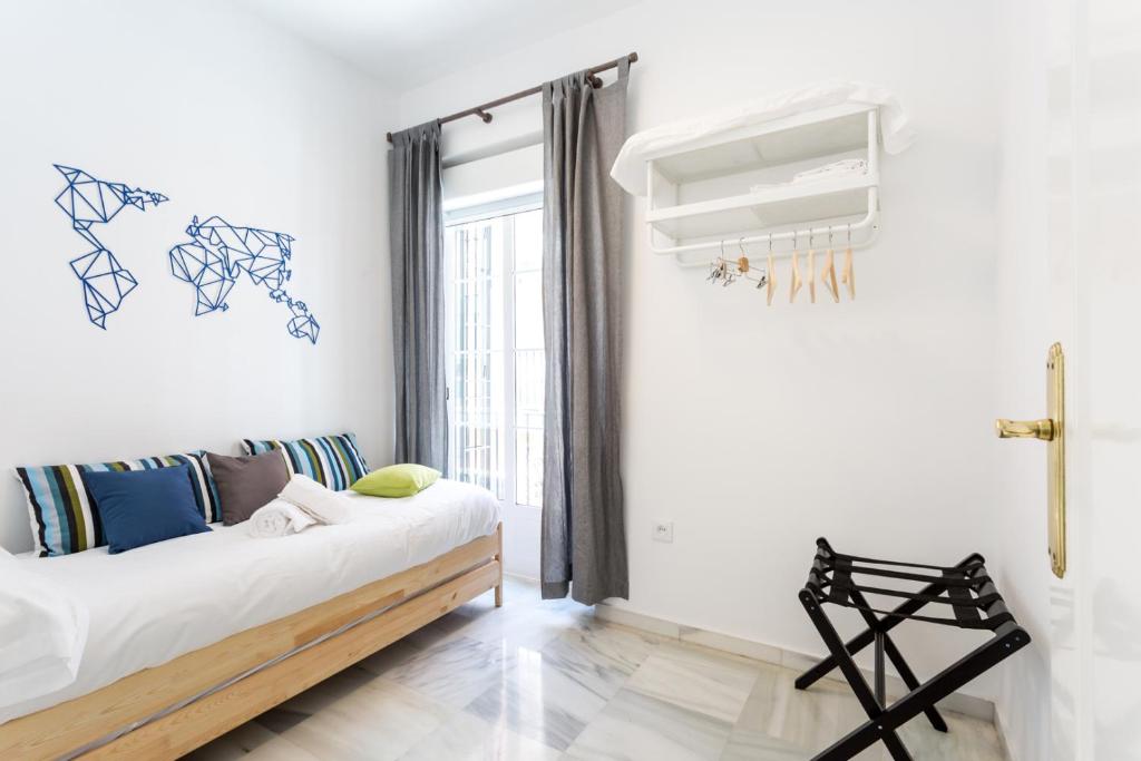 Posteľ alebo postele v izbe v ubytovaní Uniko Home Sevilla