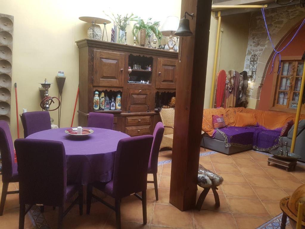 a dining room with a purple table and purple chairs at Sylvias Antique House in Nicosia