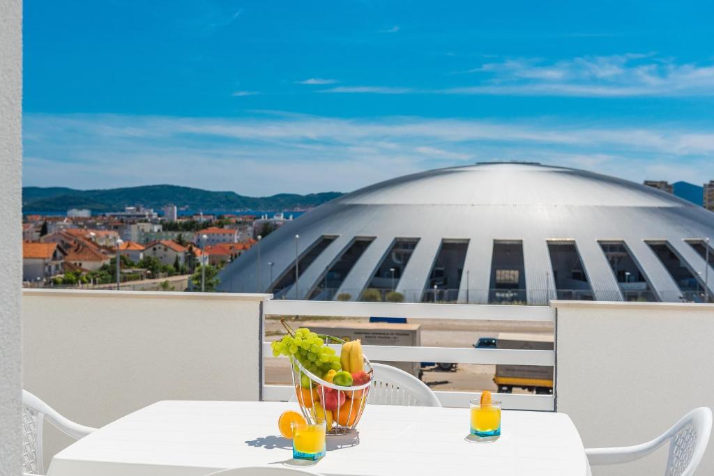 a table with a bowl of food on top of a building at Apartments HIPERION in Zadar