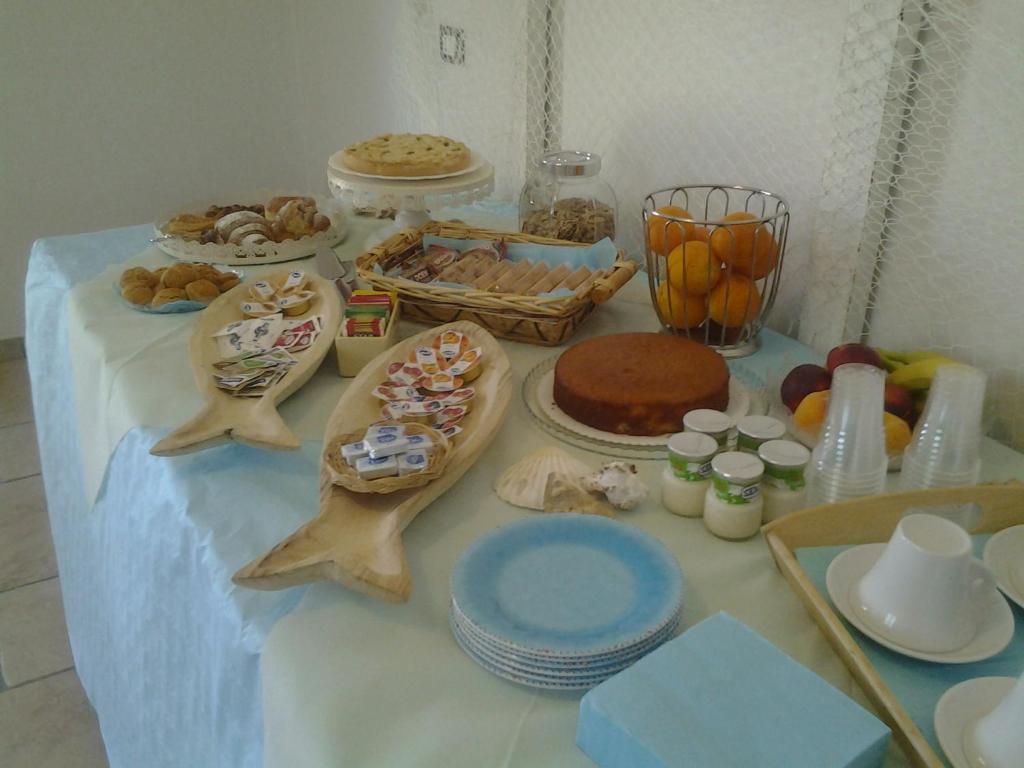 a table with a table cloth with food on it at B&B Hibiscus in Vieste