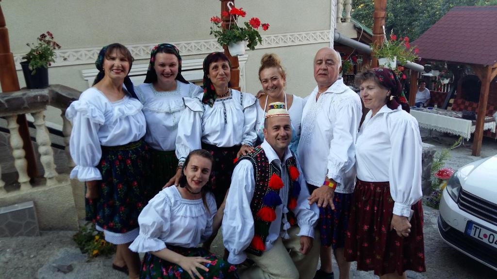 a group of people posing for a picture at Casa Ionela Petreus in Poienile Izei