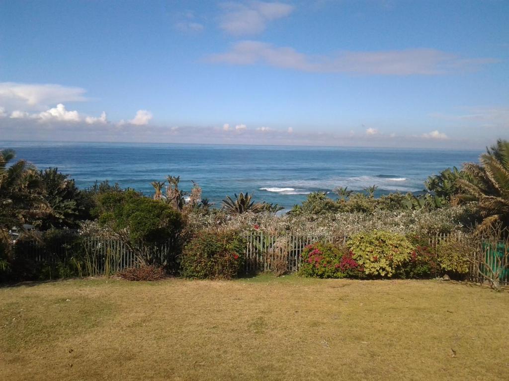 a view of the ocean from a yard at Our Beach House in Southbroom
