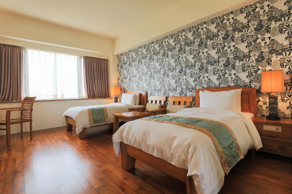 Postel nebo postele na pokoji v ubytování Yentai Hotel