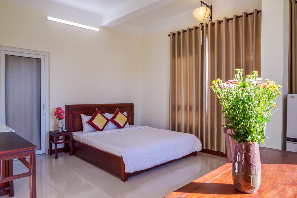 Postel nebo postele na pokoji v ubytování Hoi An Corner Homestay