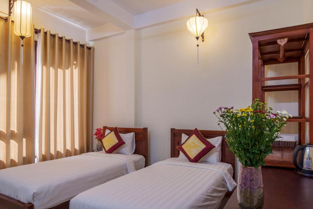 Postel nebo postele na pokoji v ubytování Hoi An Corner Homestay
