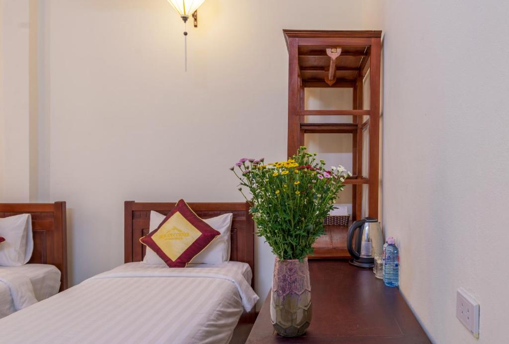 Postel nebo postele na pokoji v ubytování Hoi An Corner Homestay