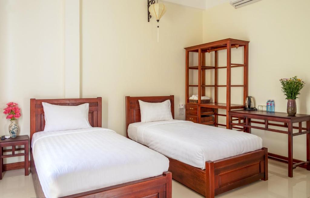 Postel nebo postele na pokoji v ubytování Hoi An Corner Homestay