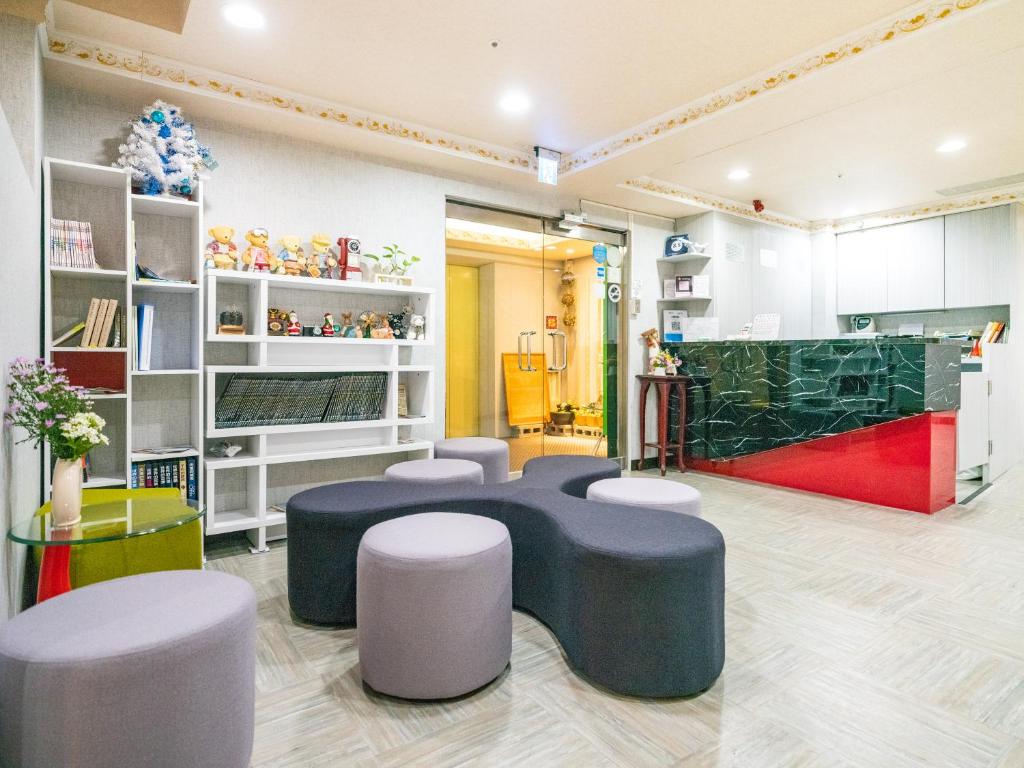 a waiting room with stools and tables in a store at Gwawa Hotel in Kaohsiung