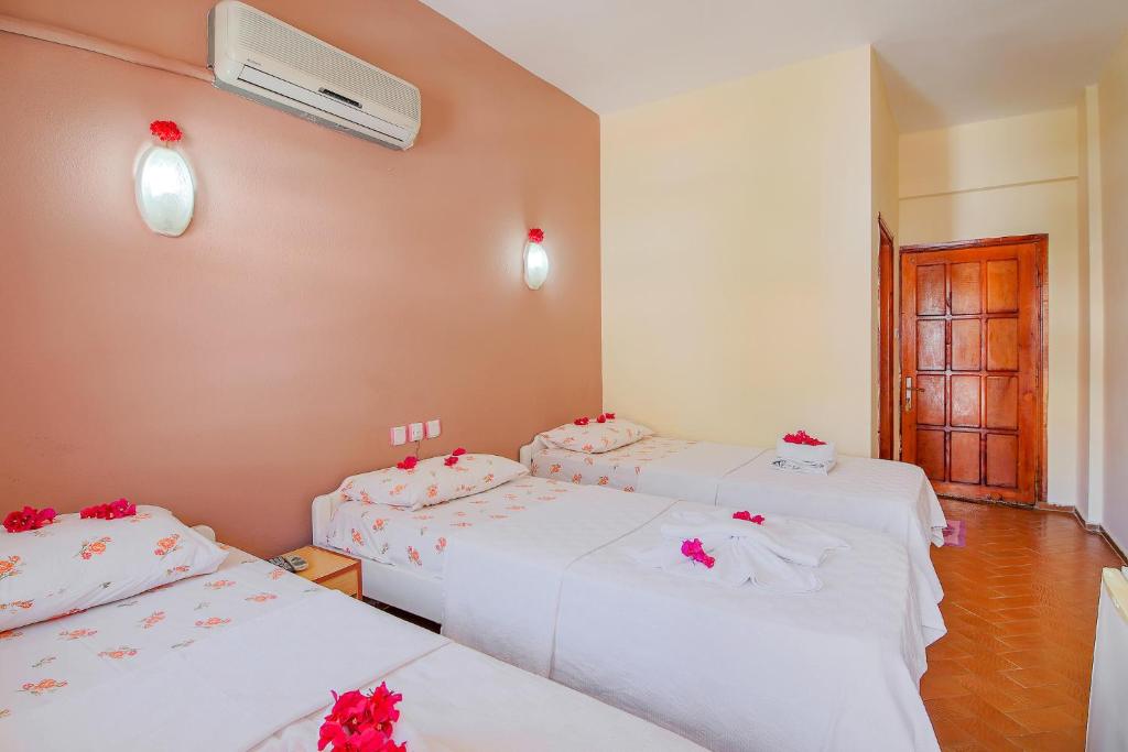 A bed or beds in a room at Saray Otel
