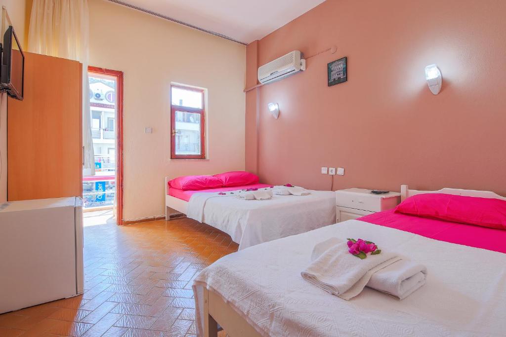 A bed or beds in a room at Saray Otel