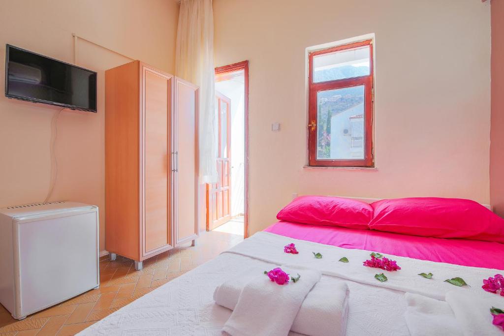 A bed or beds in a room at Saray Otel