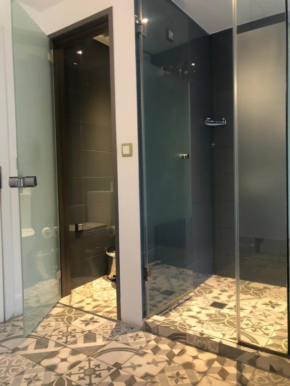 a bathroom with a glass shower with a toilet at Blue Bottle Boutique Hotel in Thessaloniki