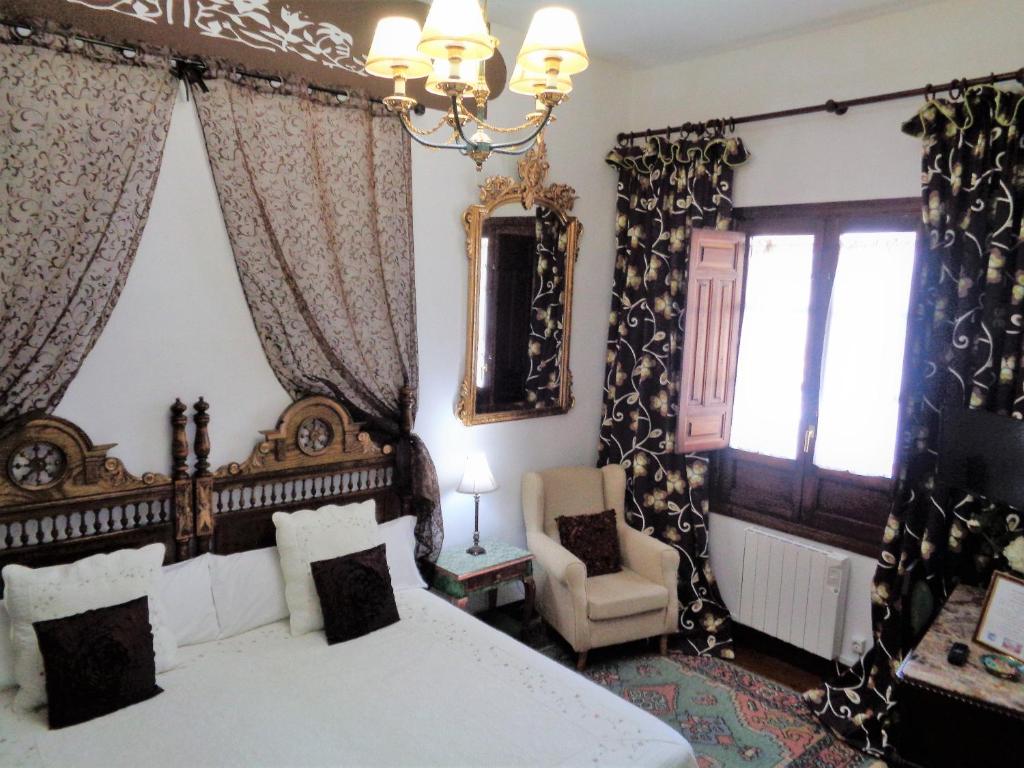 Postel nebo postele na pokoji v ubytování Hotel Boutique Nueve Leyendas