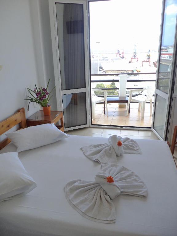 Postel nebo postele na pokoji v ubytování Poseidon Hotel